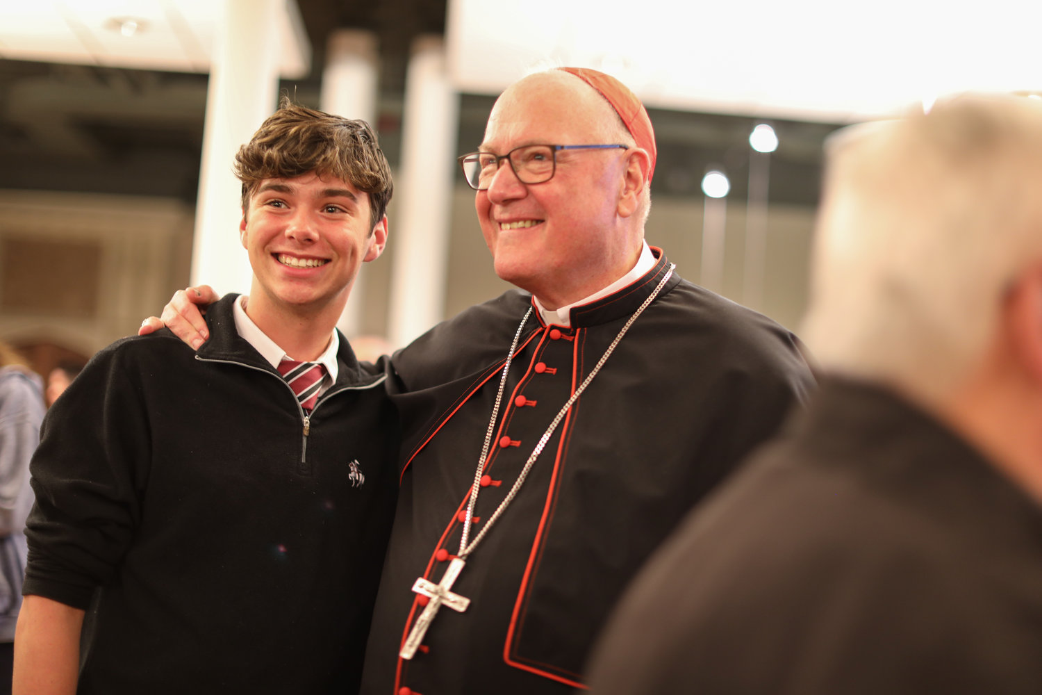 The Cardinal smiles with Thomas Simonetti, a Prout School student. The event was part of the Diocese of Providence’s 150th anniversary.